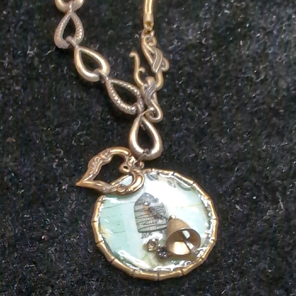 Antiqued gold colored bird in a cage pendant on sweater length 24" chain